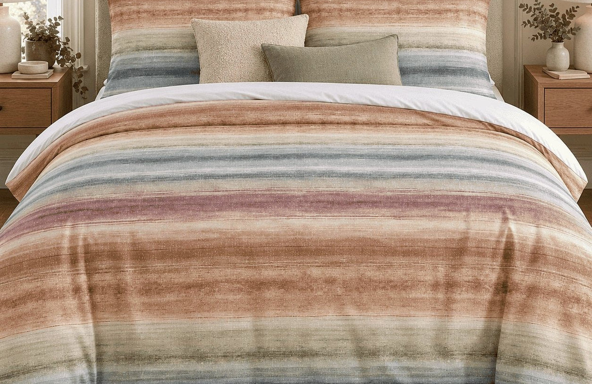 Sunset watercolour stripe duvet cover set on a bed
