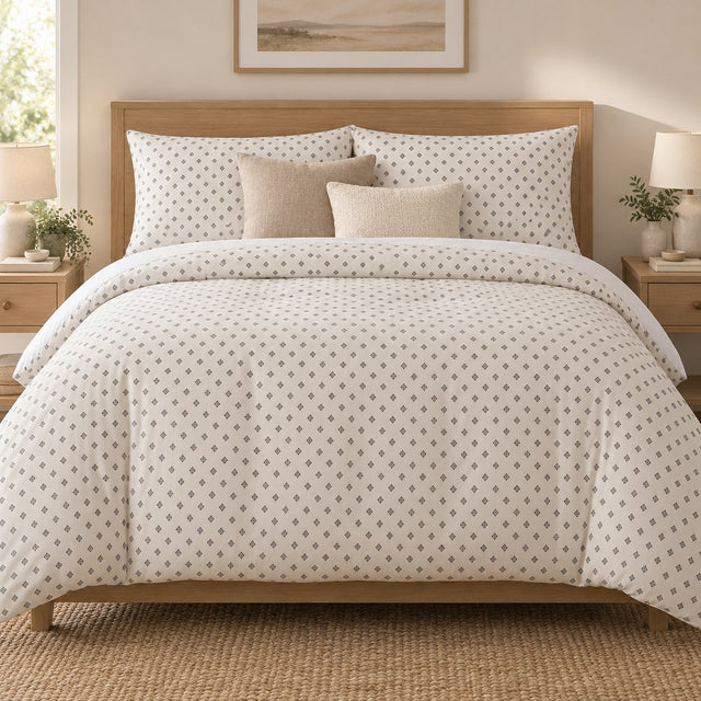 Grey Cross Stitch Geometric duvet cover set, front view showing grey diamonds on ivory with oatmeal and cream cushions