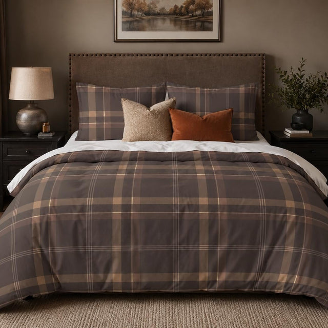 Mocha Plaid duvet cover set, front view showing grey-brown check with caramel bands and cream lines on a studded bed