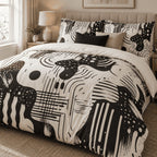 Black Ivory Retro Abstract duvet cover set, angled view showing the graphic black and ivory print beside a window