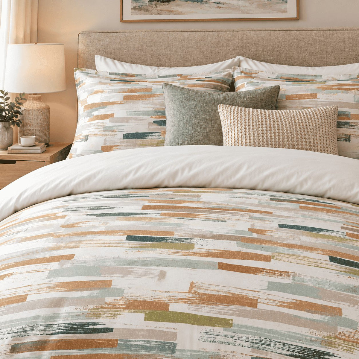 Caramel Sage Brushstroke duvet cover set, close-up of brushstroke pillowcases with sage and waffle-knit cushions