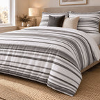 Charcoal Grey Stripe duvet cover set, angled view showing charcoal pinstripe bands and a white turndown