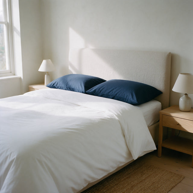 Navy Blue Cotton Blend Pillowcases on a made bed with crisp white bedding