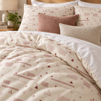 Cream Rose Retro Geometric duvet cover set, close-up of pillowcases showing pillowcases behind terracotta and oatmeal bouclé