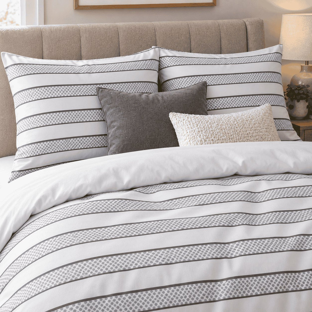 Dove Grey Dot Stripe duvet cover set, pillowcase detail showing dotted stripe pillowcases and charcoal and cream cushions