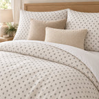 Grey Cross Stitch Geometric duvet cover set, close-up of pillowcases showing pillowcases behind oatmeal and cream bouclé