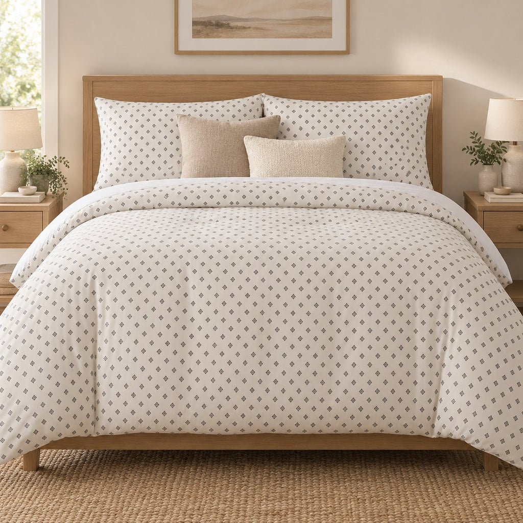 Grey Cross Stitch Geometric duvet cover set, front view showing grey diamonds on ivory with oatmeal and cream cushions