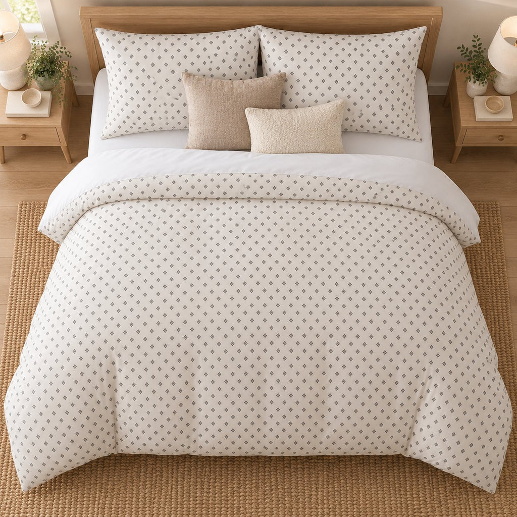 Grey Cross Stitch Geometric duvet cover set, overhead view showing the full bed on a jute rug between oak bedside tables