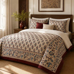 Ivory Burgundy Framed Heritage duvet cover set, angled view showing the blue vine border and burgundy edge in sunlight