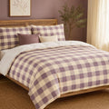 Lavender Plaid duvet cover set, angled view showing lavender and cream buffalo check on an oak bed with cane headboard