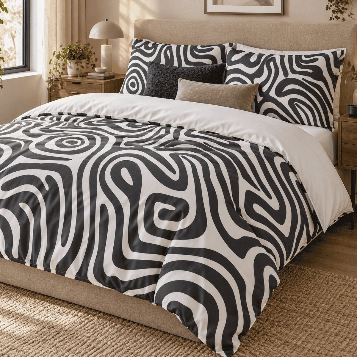 Monochrome Swirl Abstract duvet cover set, angled view showing bullseye swirls and pillowcases beside a window