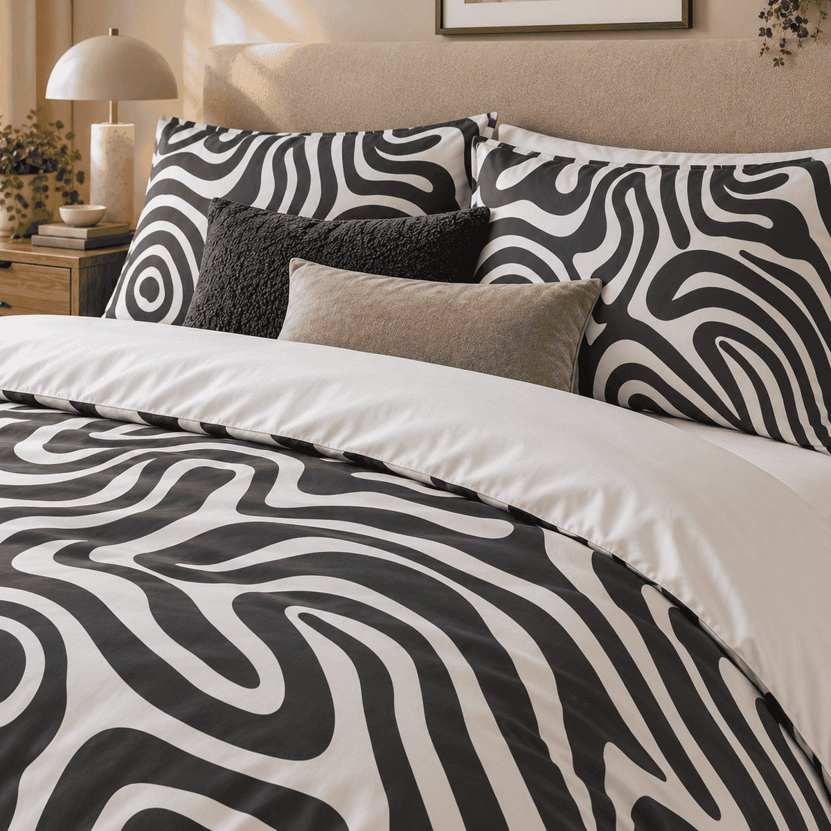 Monochrome Swirl Abstract duvet cover set, close-up of swirl pillowcases with charcoal boucle and taupe cushions