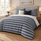 Navy Breton Stripe duvet cover set, angled view showing white Breton stripes on navy under a coastal print