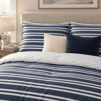 Navy Breton Stripe duvet cover set, pillowcase detail showing striped pillowcases, cream bouclé and navy velvet cushions