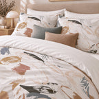 Neutral Brushmark Abstract duvet cover set, close-up of printed pillowcases with charcoal and terracotta cushions