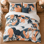 Orange Navy Splash Abstract duvet cover set, overhead view showing the full splash print with orange and navy cushions