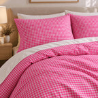 Hot Pink Gingham duvet cover set, close-up of pillowcases showing a hot pink gingham pillowcase above the turned-down duvet