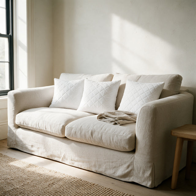 Three Quilted Cushion Inserts on an oat linen sofa