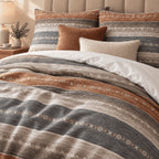 Slate Rust Woven Stripe duvet cover set, turndown detail showing rust and slate bands with rows of small ivory folk motifs