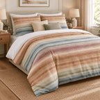 Sunset Watercolour Stripe duvet cover set, angled view showing blended sunset stripes, oatmeal and sage cushions