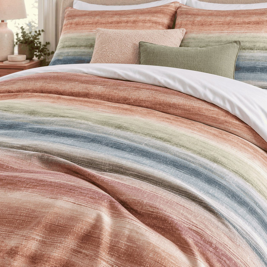 Sunset Watercolour Stripe duvet cover set, turndown detail showing brushed terracotta, peach and sage stripes fading together