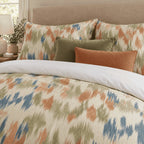Terracotta Sage Ikat duvet cover set, close-up of ikat pillowcases with olive velvet and rust cushions
