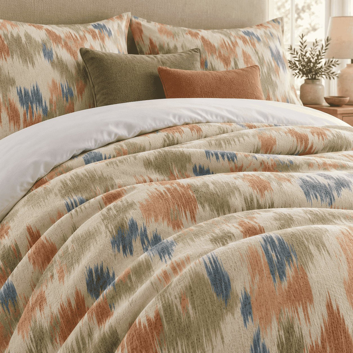 Terracotta Sage Ikat duvet cover set, close-up showing feathered terracotta, sage and denim blue flashes