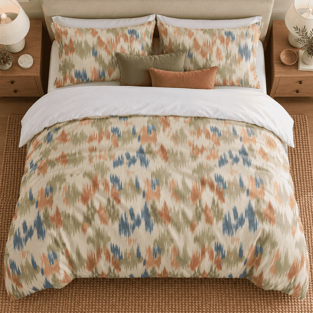 Terracotta Sage Ikat duvet cover set, overhead view showing the full ikat print with olive and rust cushions