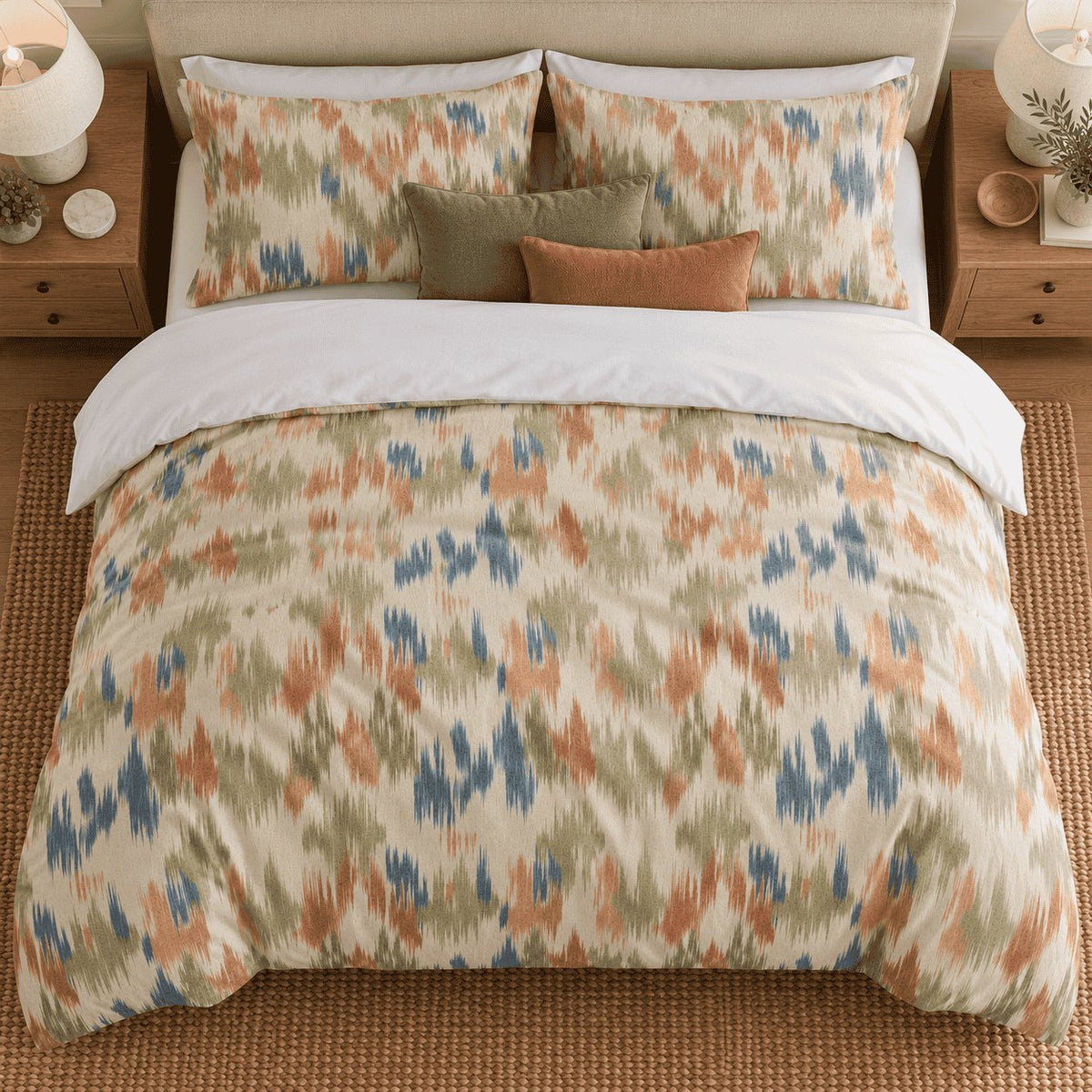 Terracotta Sage Ikat duvet cover set, overhead view showing the full ikat print with olive and rust cushions