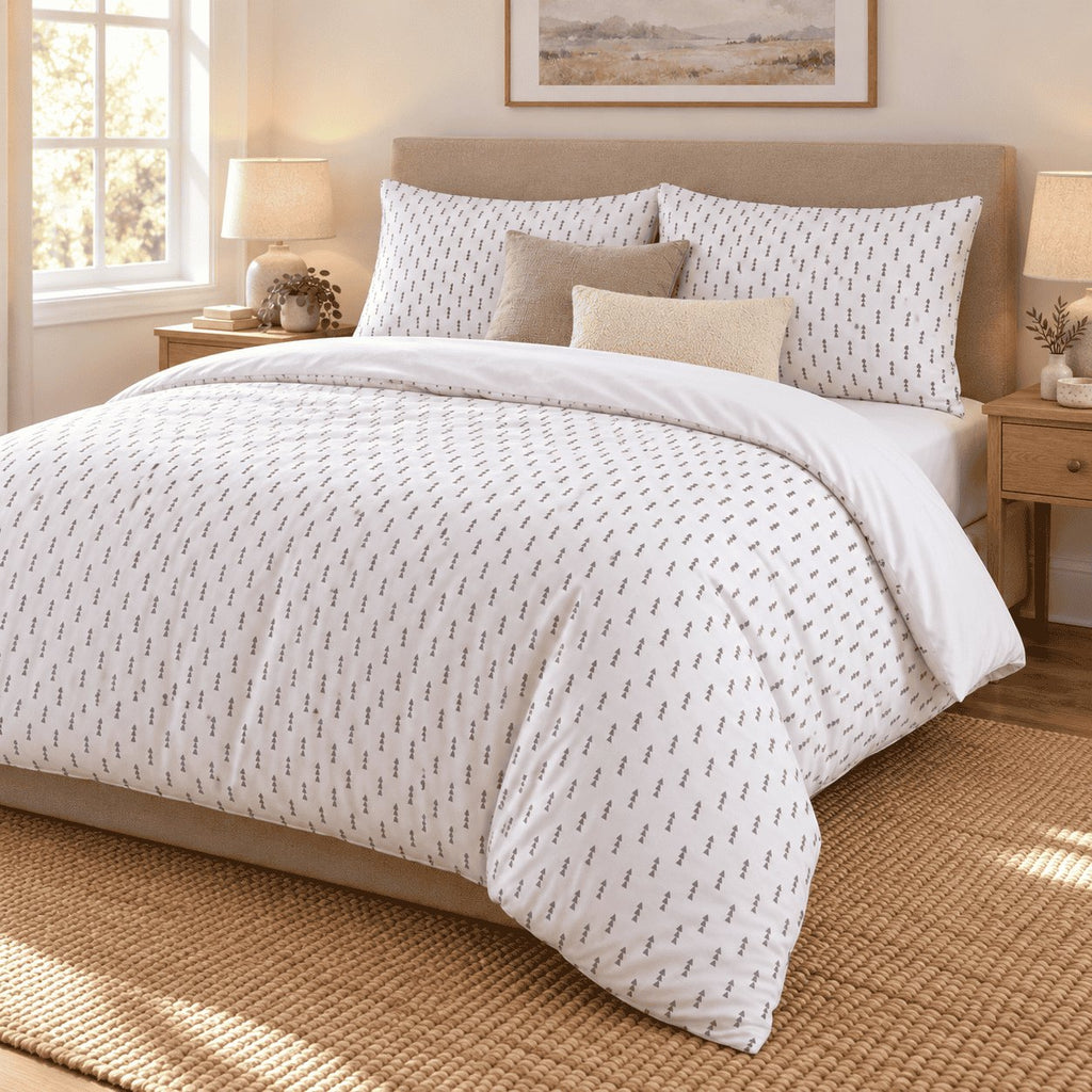 White Grey Triangle Arrow duvet cover set, angled view showing rows of grey arrows on white falling past the bed frame