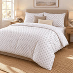 White Grey Triangle Arrow duvet cover set, angled view showing rows of grey arrows on white falling past the bed frame