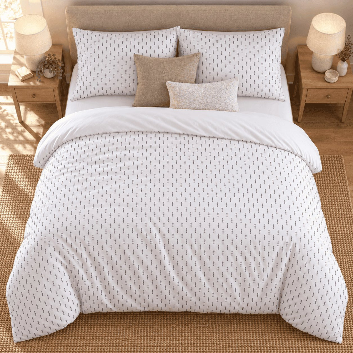 White Grey Triangle Arrow duvet cover set, overhead view showing the full bed on a jute rug between oak bedside tables