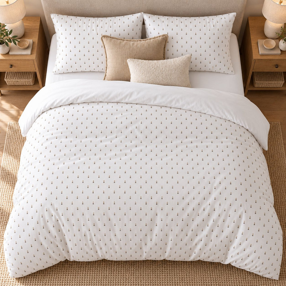 White Taupe Pebble Stack duvet cover set, overhead view showing the white duvet spread over a jute rug with oak bedside tables