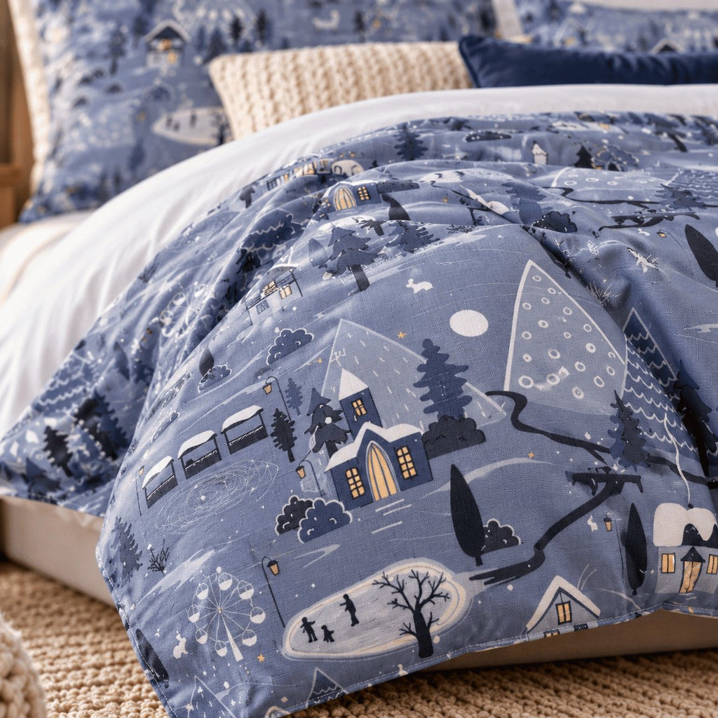 Winter Village Christmas duvet cover set, print close-up showing skaters on a pond, lit cottages and a Ferris wheel